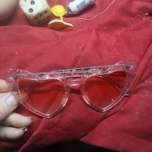 sunglasses appear to be Long Keeper vintage heart-shaped glasses